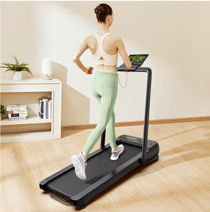 A woman running on a UREVO Strol 2S Pro Treadmill in a cozy home setting.