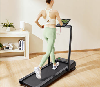 A woman running on a UREVO Strol 2S Pro Treadmill in a cozy home setting.