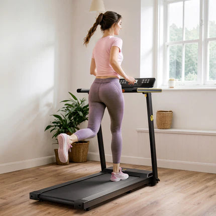 A woman in pink and purple workout clothes running on a treadmill in a bright room with a plant.