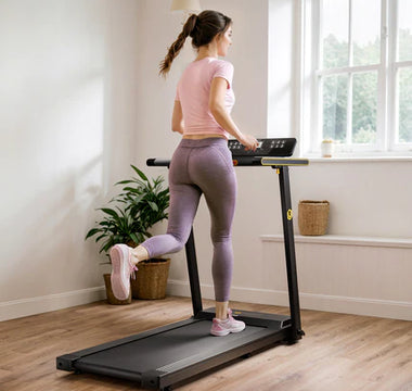 A woman in a pink top and purple leggings is running on a treadmill in a bright room.