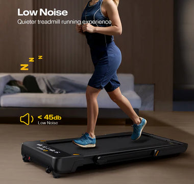 A woman is running on a quiet treadmill in a living room, with a person sleeping on a sofa in the background.