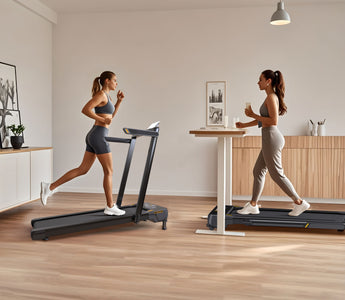 Two women are exercising on treadmills in a modern, minimalist room with wooden floors